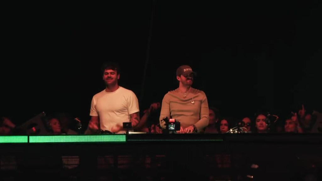 The Chainsmokers performing on stage in front of a crowd.