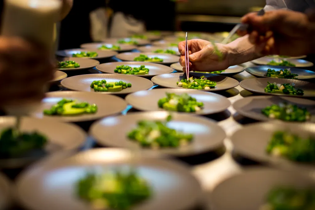 Chef David Barzelay plating courses of dishes at Lazy Bear restaurant.