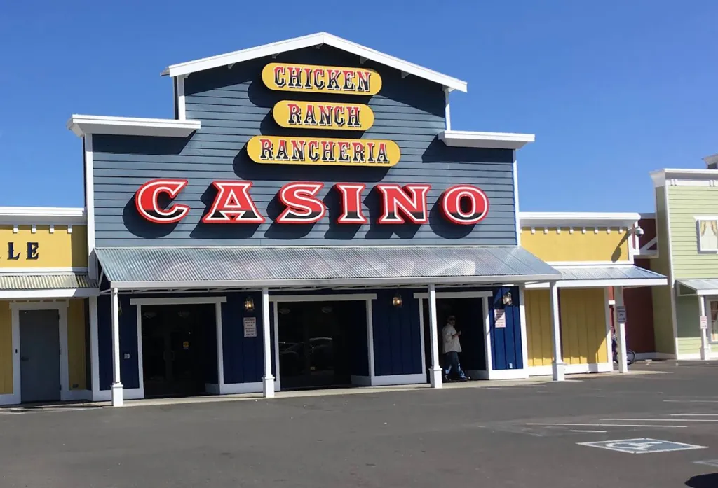 The exterior of the Chicken Ranch Rancheria Casino, featuring a blue facade with 