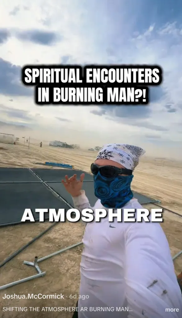 A person in a bandana, sunglasses, and blue face covering stands in a desert with the text