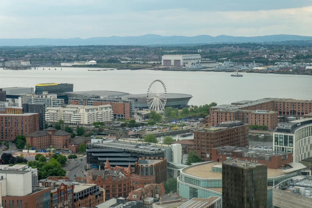 Cityscape of Liverpool with the Wheel of Liverpool and M&S Bank Arena by the river.