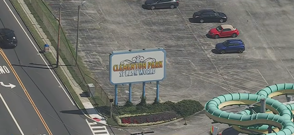 Aerial view of Clementon Park Splash World sign next to a parking lot and road.