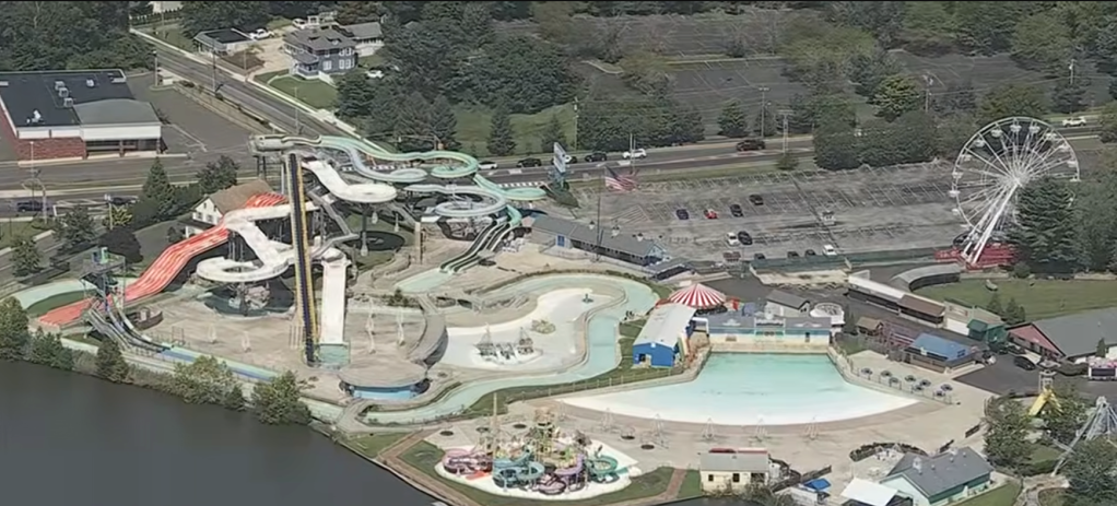 Aerial view of Clementon Park and Splash World, showing waterslides, a Ferris wheel, and a lake.