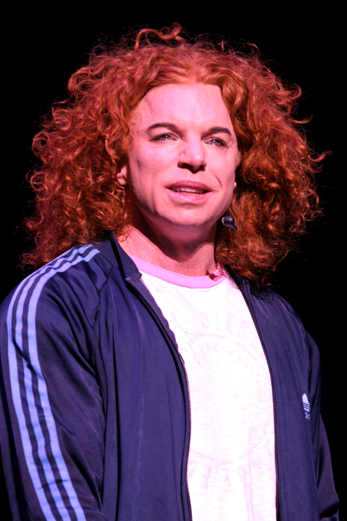Carrot Top performing on stage.