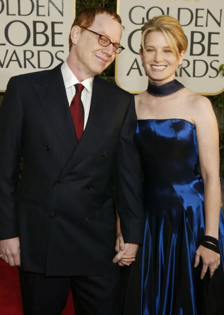 Composer Danny Elfman and actress Bridget Fonda holding hands at the Golden Globe Awards.
