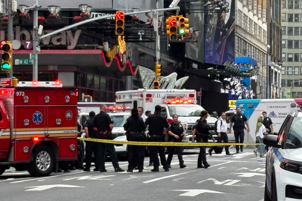 Crime scene established in Times Square with police and emergency vehicles.