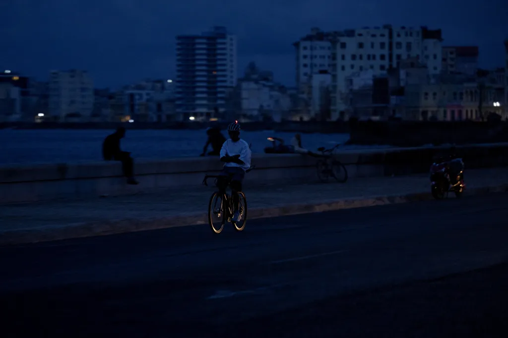 A cyclist rides along the darkened Malecon during a power outage in Havana, Cuba, on Sept. 18, 2026.