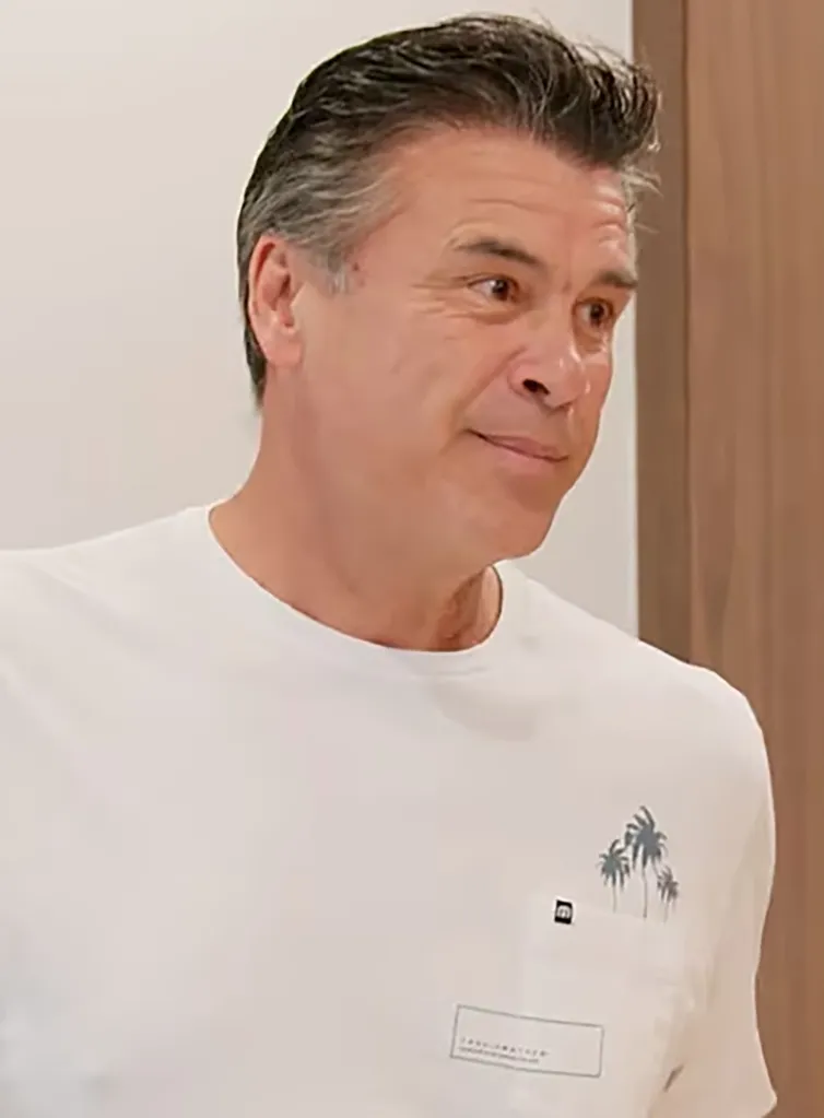 Danny Hampel in a white t-shirt with palm tree graphics.