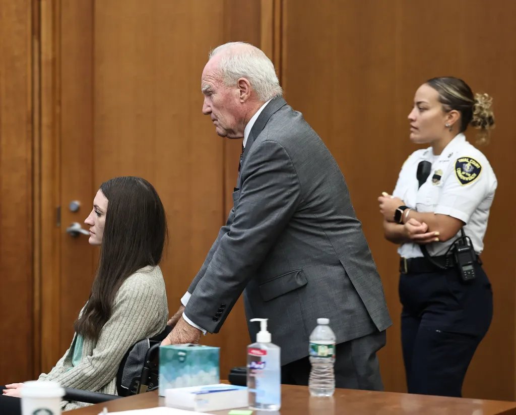Defense attorney Kevin Reddington pushes Lindsay Clancy in her wheelchair during her trial.
