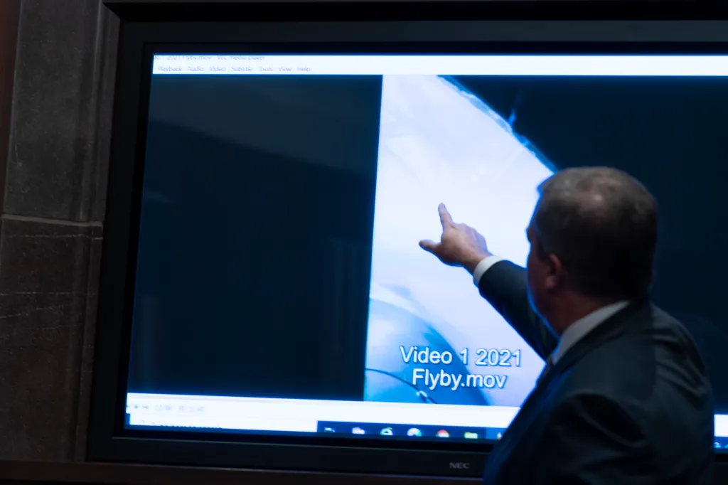 Deputy Director of Naval Intelligence Scott Bray points to a video display of a UAP during a House Intelligence, Counterterrorism, Counterintelligence, and Counterproliferation Subcommittee hearing on