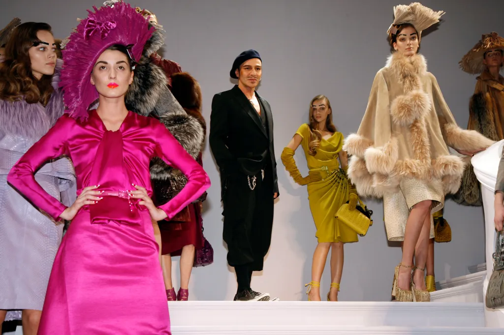 Designer John Galliano and models walk the runway at the Christian Dior fashion show during Paris Fashion Week.