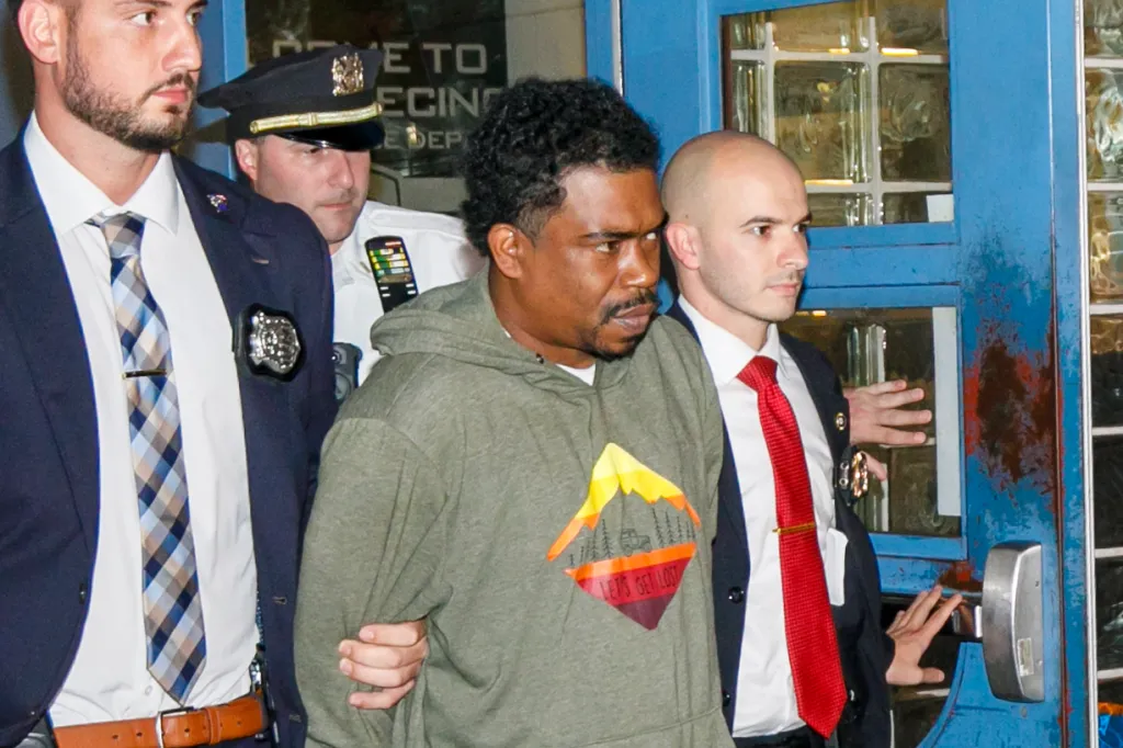 Tiliek Shamel Thompson, 41, is escorted by detectives from the 33rd Precinct in Washington Heights on Saturday after being charged with murder in the death of Lovay Williams.