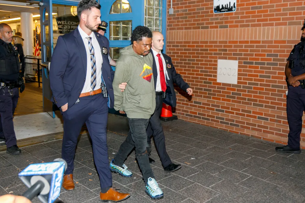 Detectives lead Tiliek Shamel Thompson, 41, out of the 33rd Precinct after his arrest in connection with the killing of Lovay Williams.