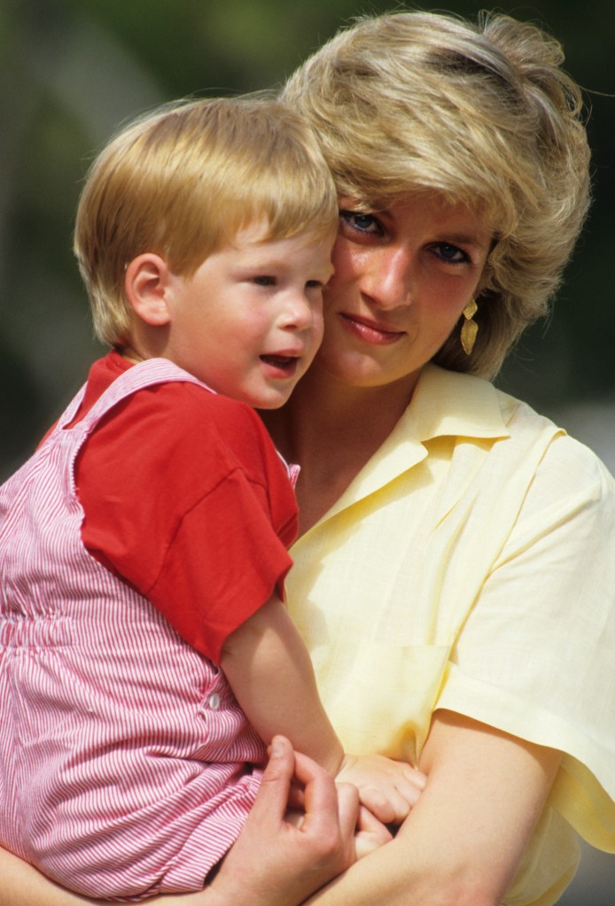 Princess Diana holding a young Prince Harry.