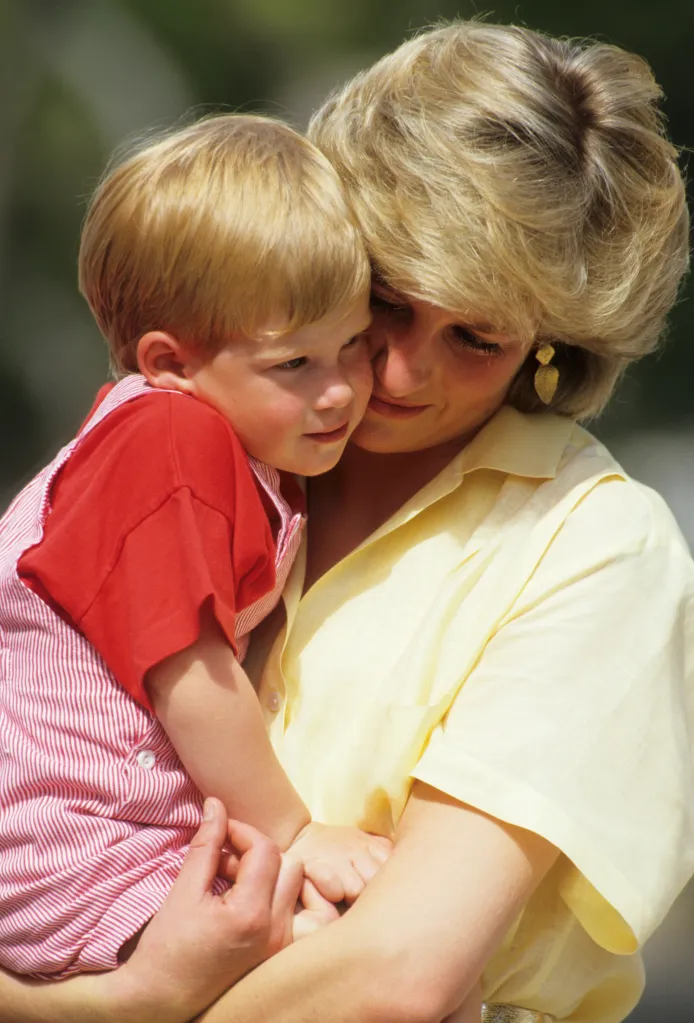 Princess Diana holding a young Prince Harry.