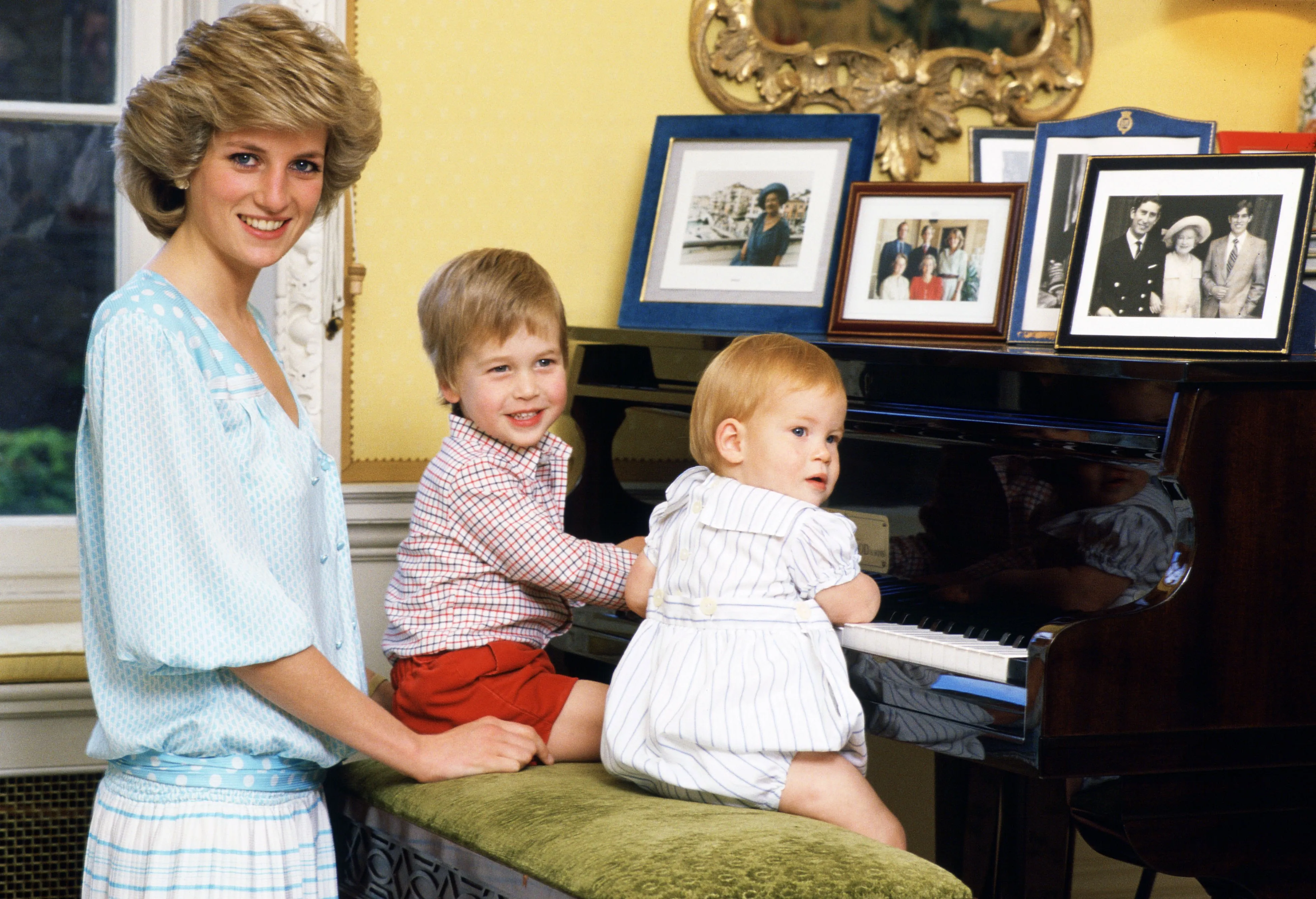 Princess Diana, with sons Prince William and Prince Harry at a piano in Kensington Palace.