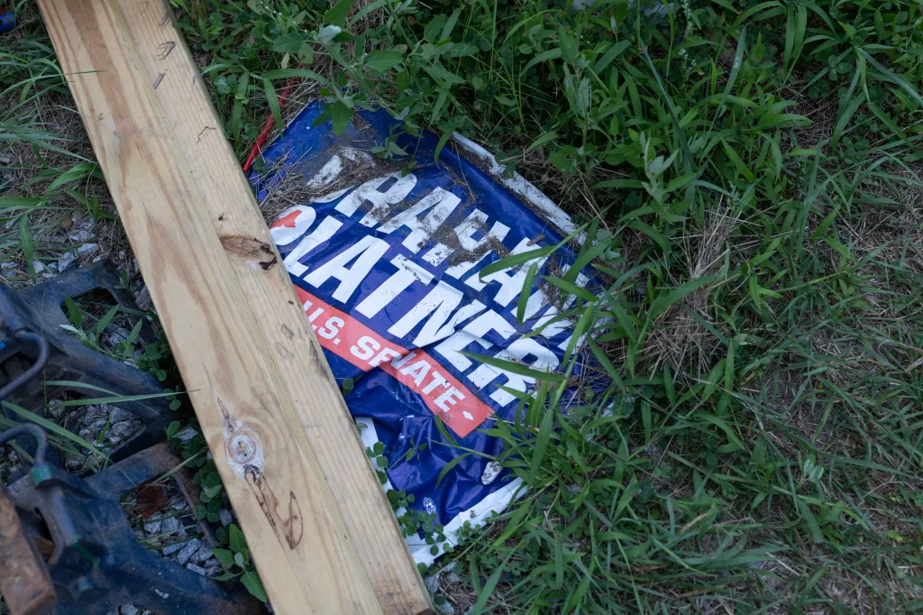 A discarded Graham Platner campaign sign is seen at a home in the White Mountain National Forest on Wednesday, Aug. 5, 2026, in Stow, Maine.