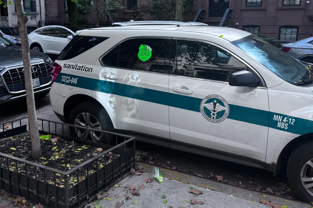 A New York City Department of Sanitation vehicle with a green