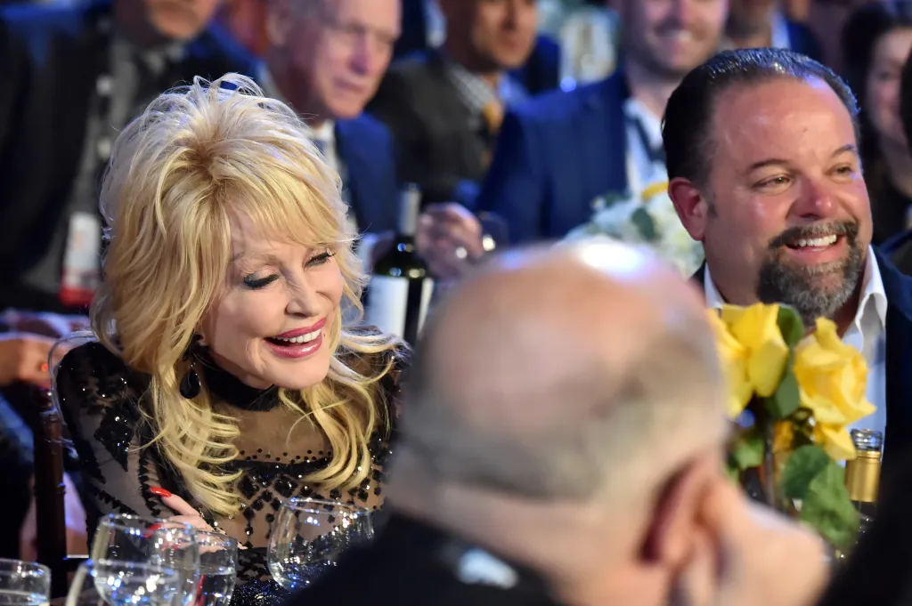 Dolly Parton and Danny Nozell smile at the MusiCares Person of the Year event.