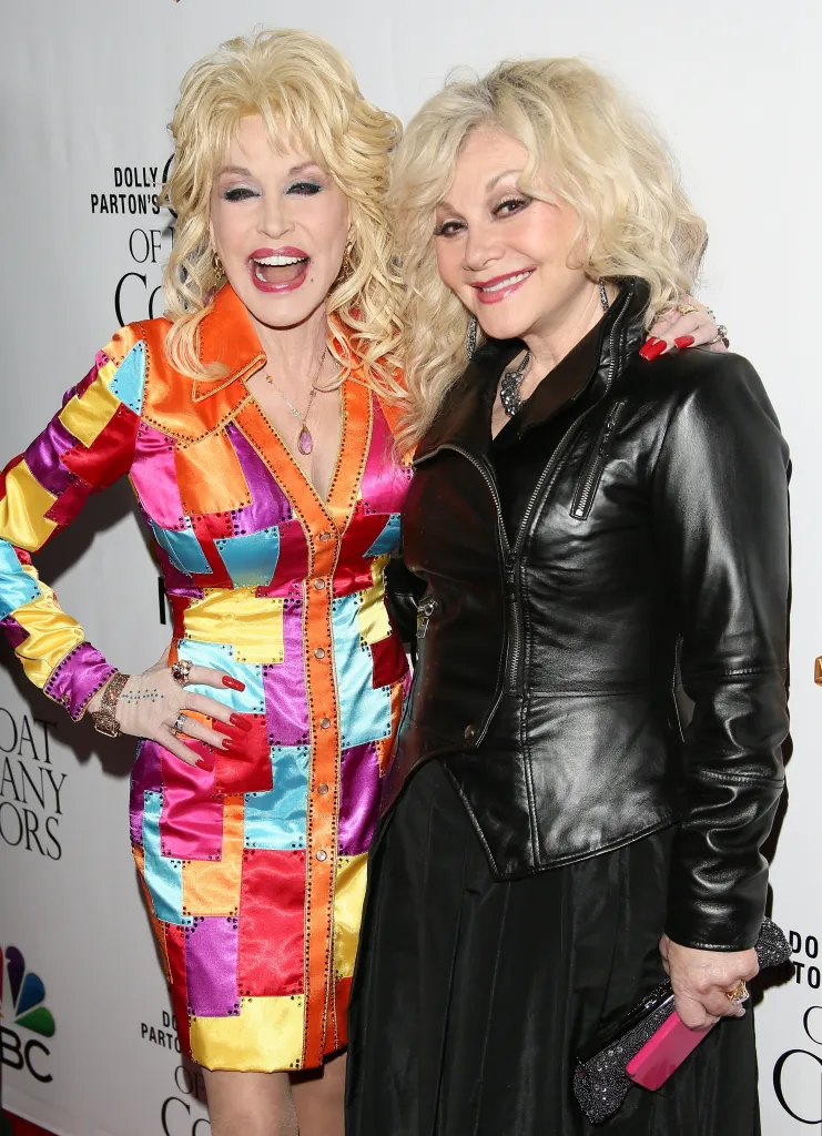 Dolly Parton in a multicolored dress and Stella Parton in a black leather jacket.