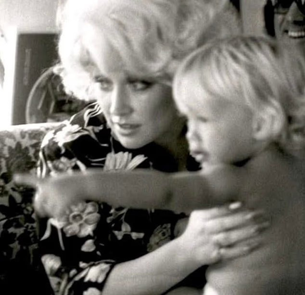 Dolly Parton with her nephew Bryan Seaver, who is pointing his finger.