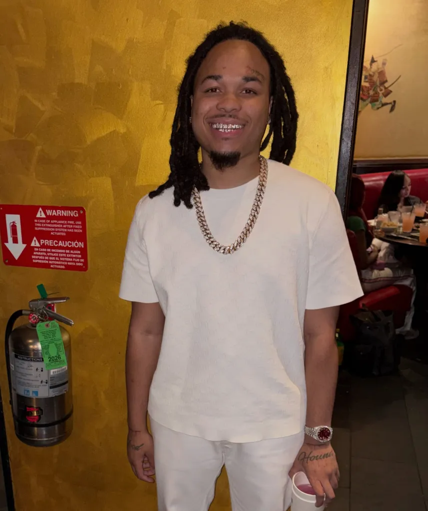 Mikquale T. Cooper, also known as drill rapper Bloodhound Q50, smiles at the camera.