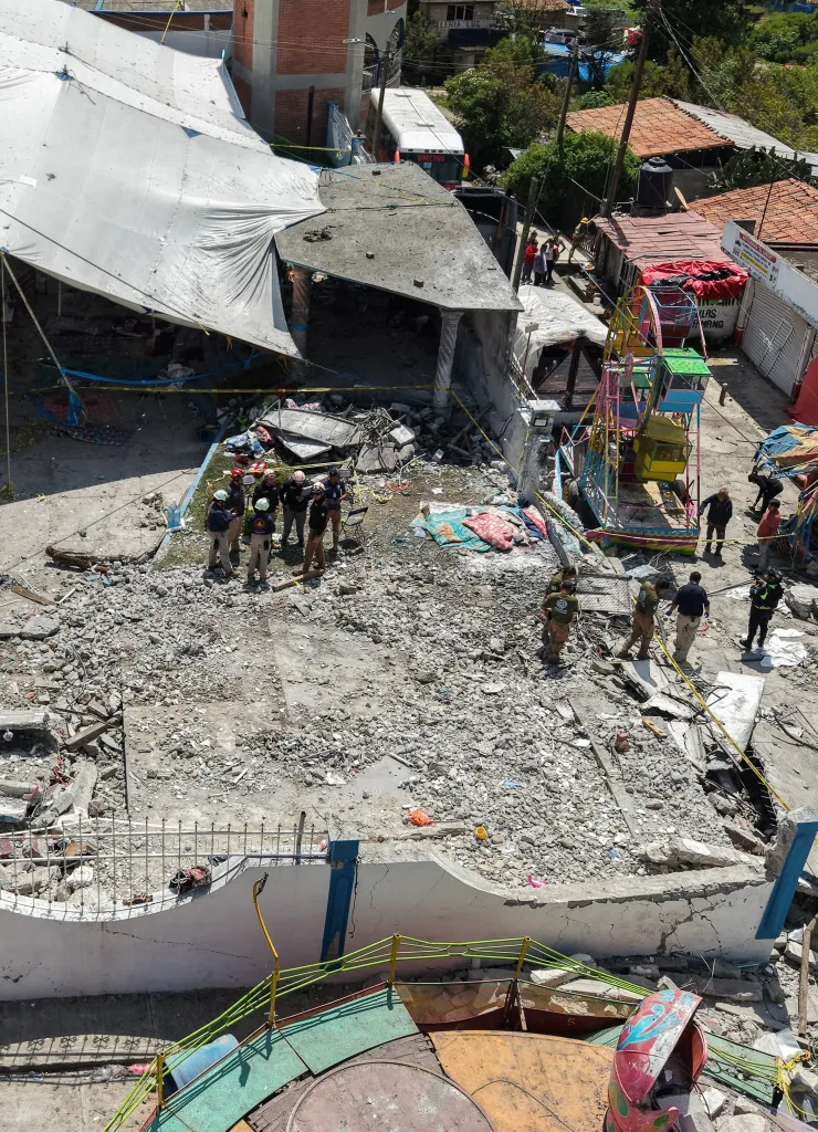 Drone view of the damage in Santa Maria Canchesda after a fireworks explosion, showing debris, damaged structures, and emergency personnel.
