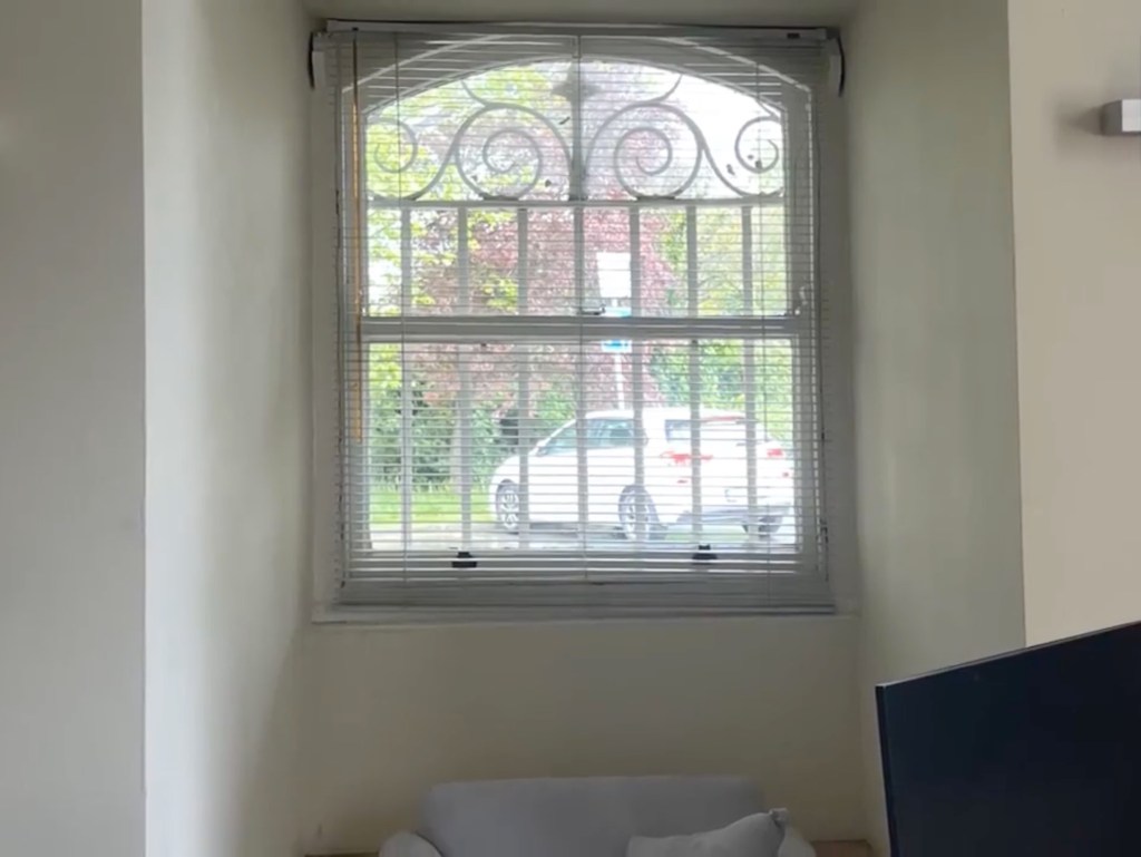A deep-set window within a University College Dublin building, with parts of the medieval Roebuck Castle surviving inside.