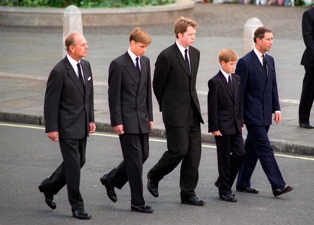 The Duke of Edinburgh, Prince William, Earl Spencer, Prince Harry, and The Prince of Wales walk together in mourning clothes.