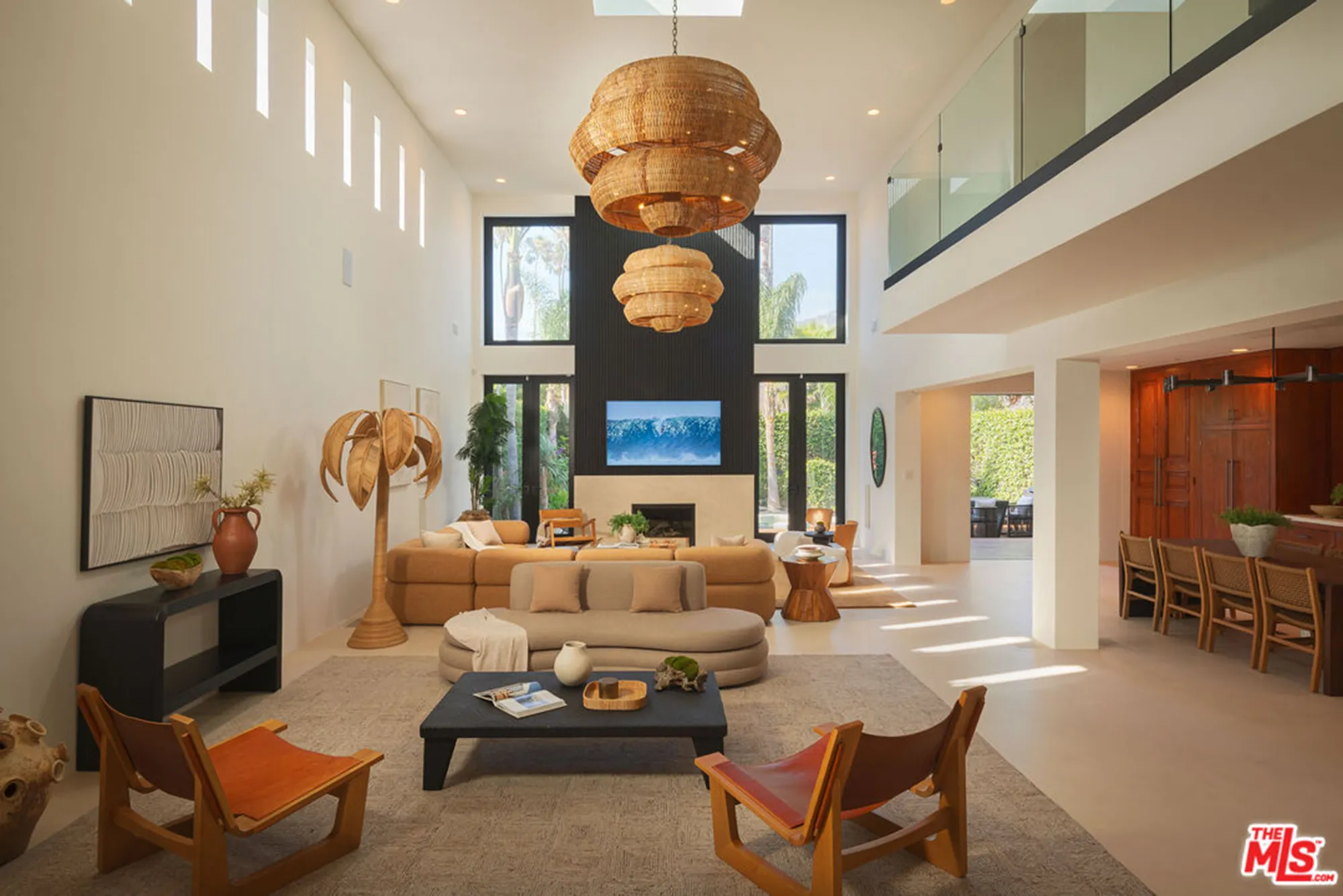 Modern living room with a brown sectional sofa, fireplace, and flat-screen TV.