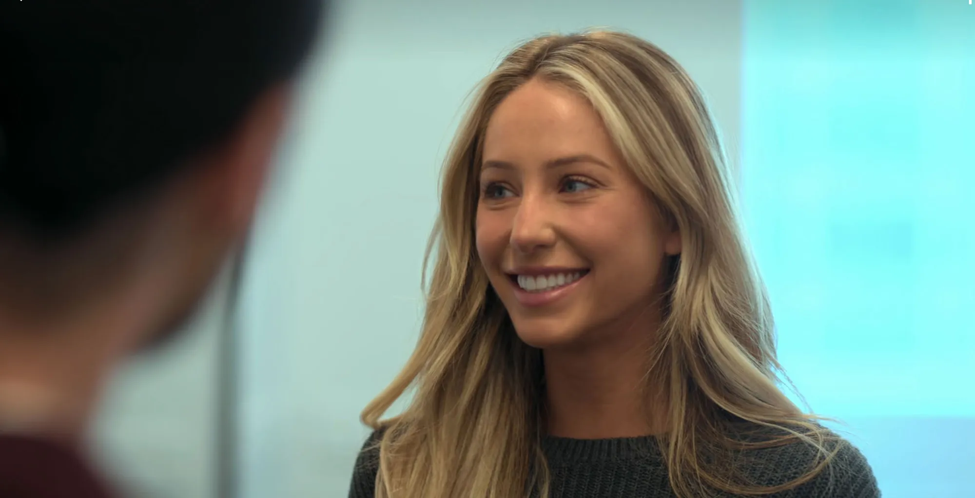 Alix Earle smiling at someone off-camera.