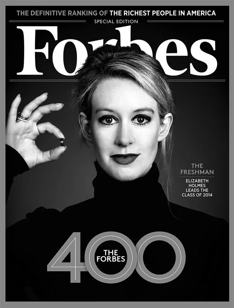 Elizabeth Holmes on the cover of Forbes magazine, holding a small medical capsule.