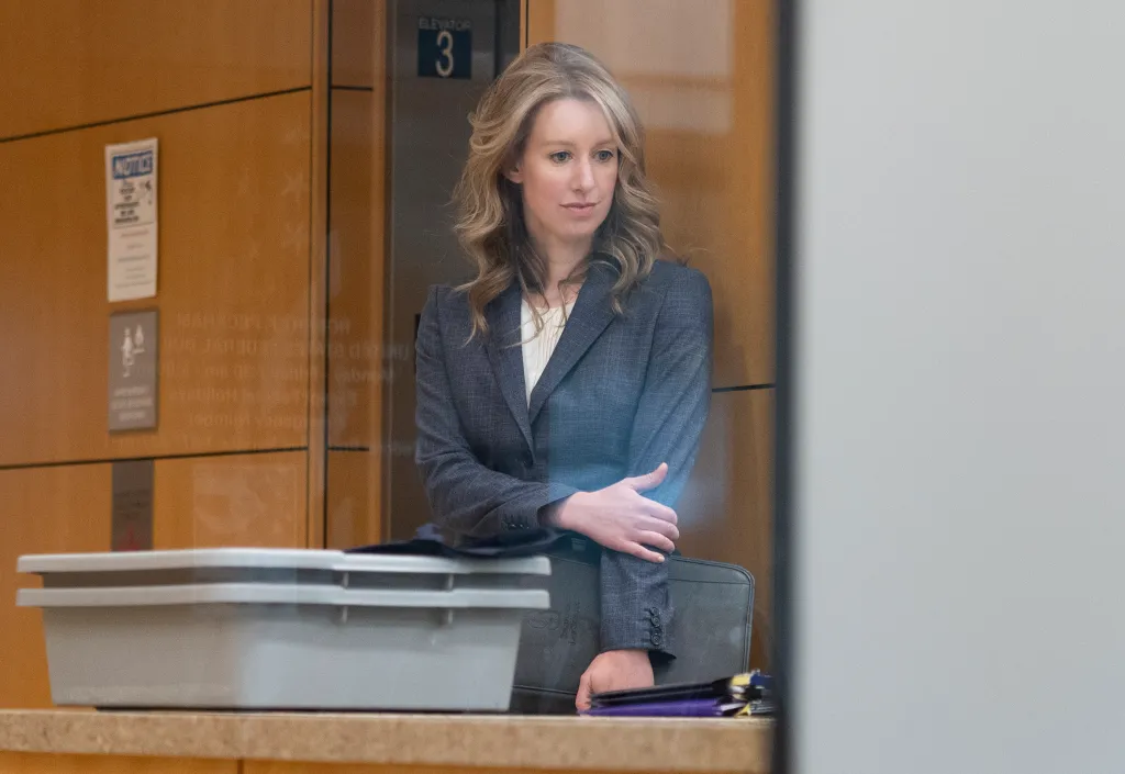 Elizabeth Holmes stands inside a building during her court hearing.