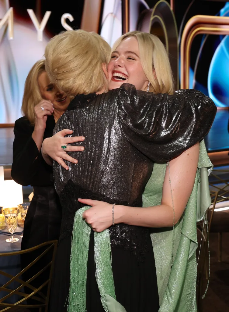 Elle Fanning embracing someone at the 78th Primetime Emmy Awards.