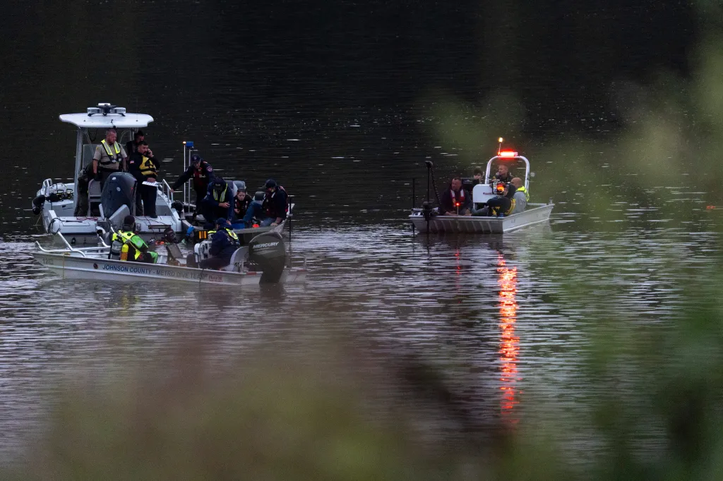 Emergency response personnel in boats search a portion of the Iowa River near the Lake Macbride spillway.