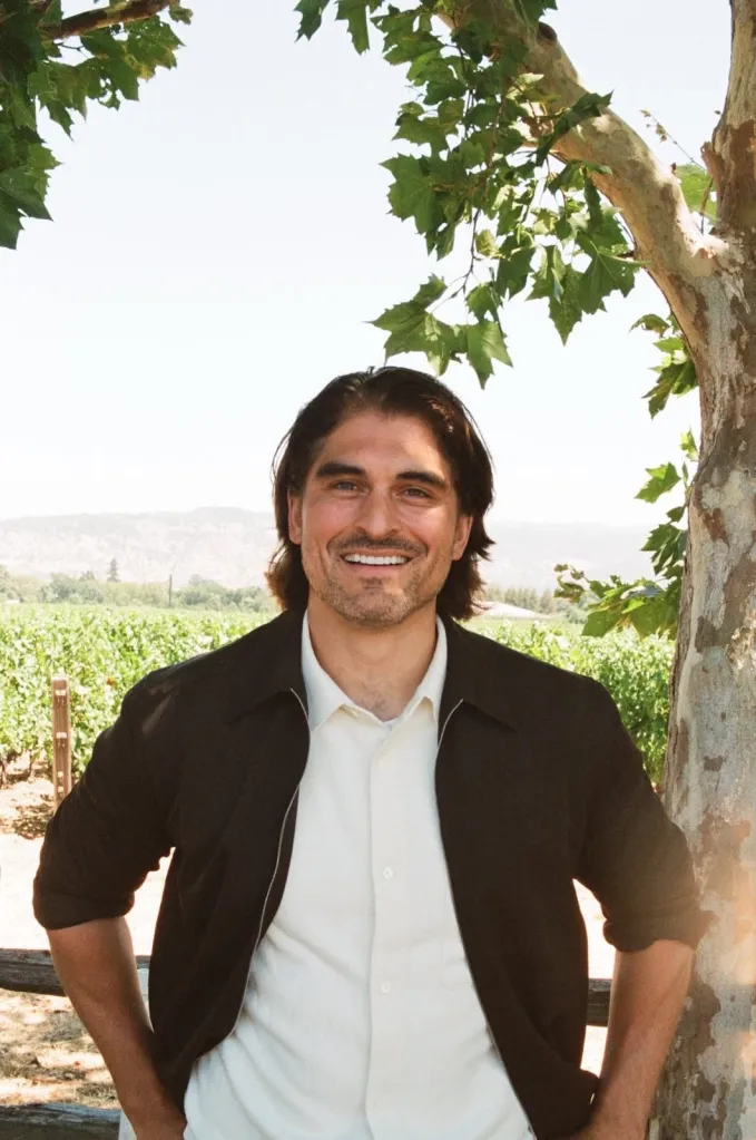 Eric Jones, Democratic candidate for Congress in California's fourth congressional district, smiling outdoors in front of a vineyard.