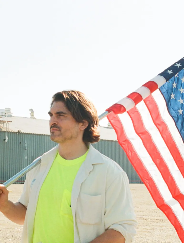 Democratic candidate Eric Jones holding an American flag.