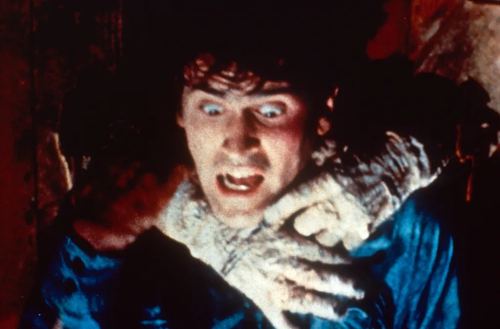 Bruce Campbell as Ash Williams being strangled in The Evil Dead.
