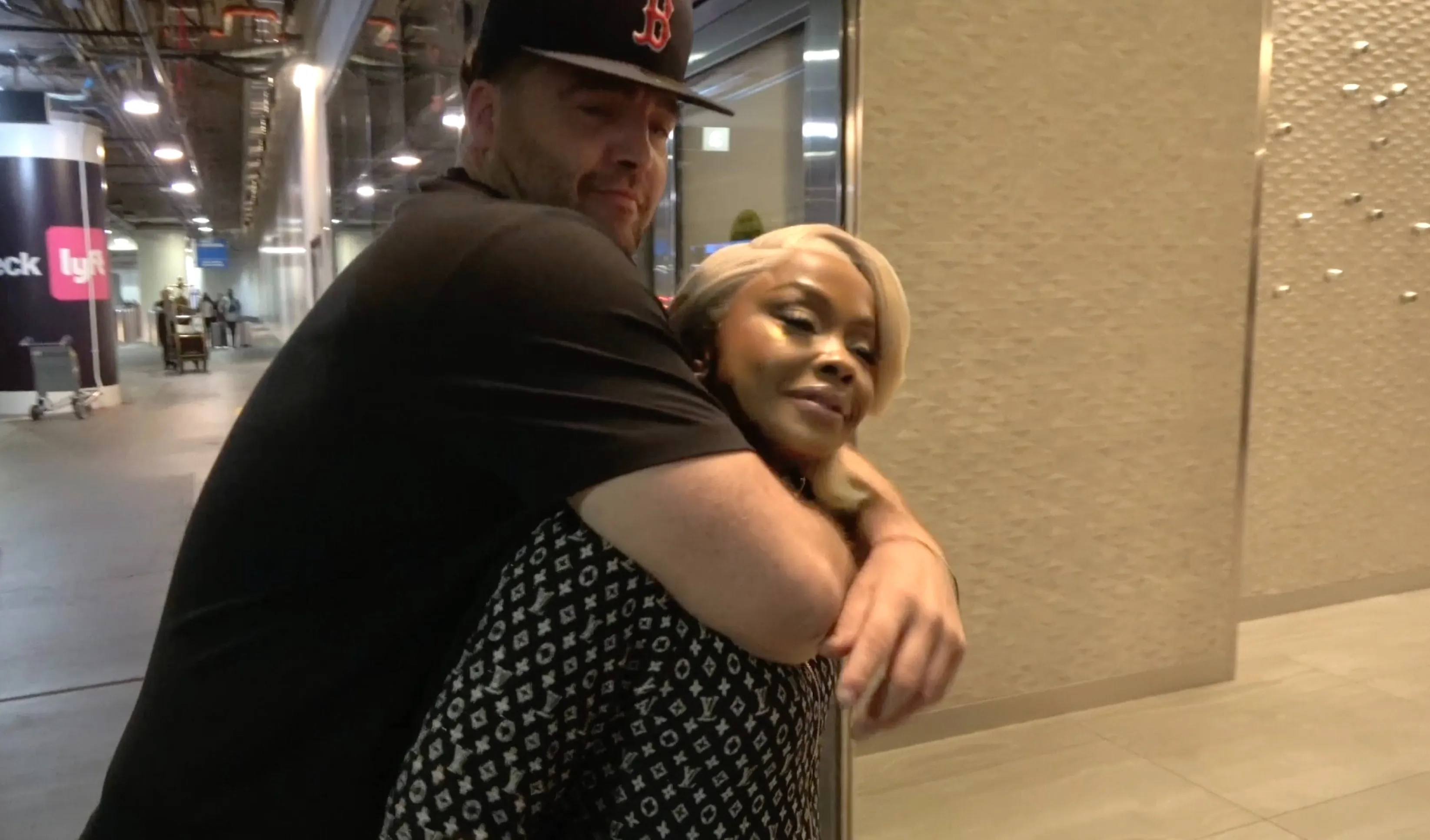 Phaedra Parks and CT Tamburello embracing in an airport.