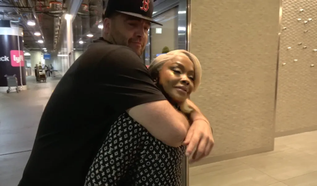 Phaedra Parks and CT Tamburello embracing at an airport.