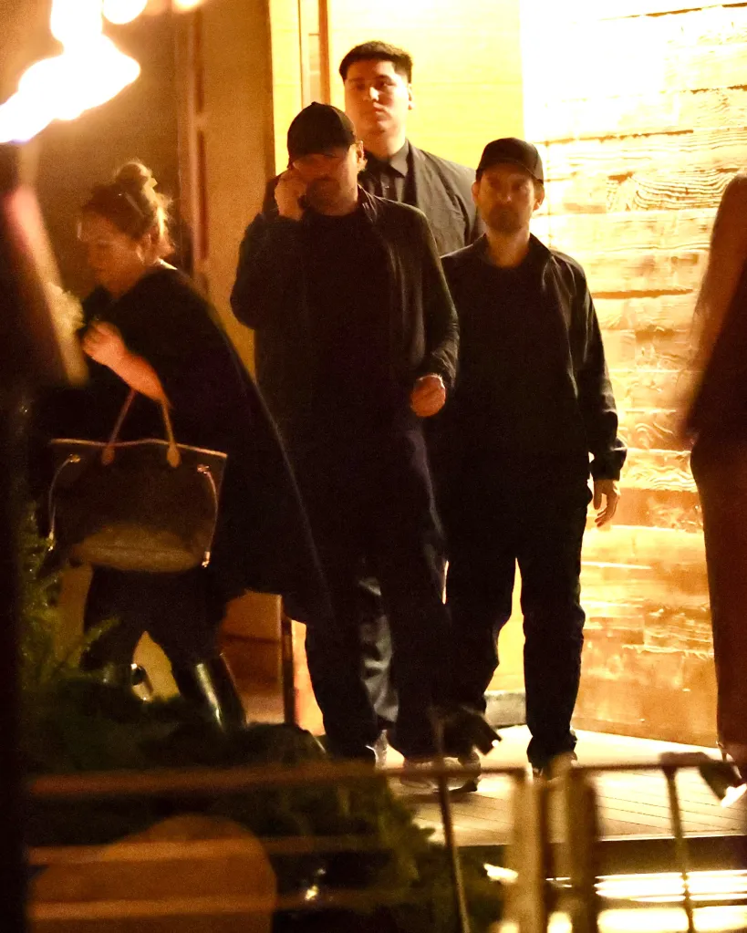 Leonardo DiCaprio, Tobey Maguire, and others leaving Nobu Malibu restaurant at night.