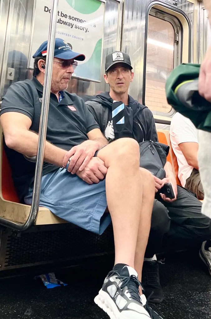 Adrien Brody and a friend riding the subway in New York City.