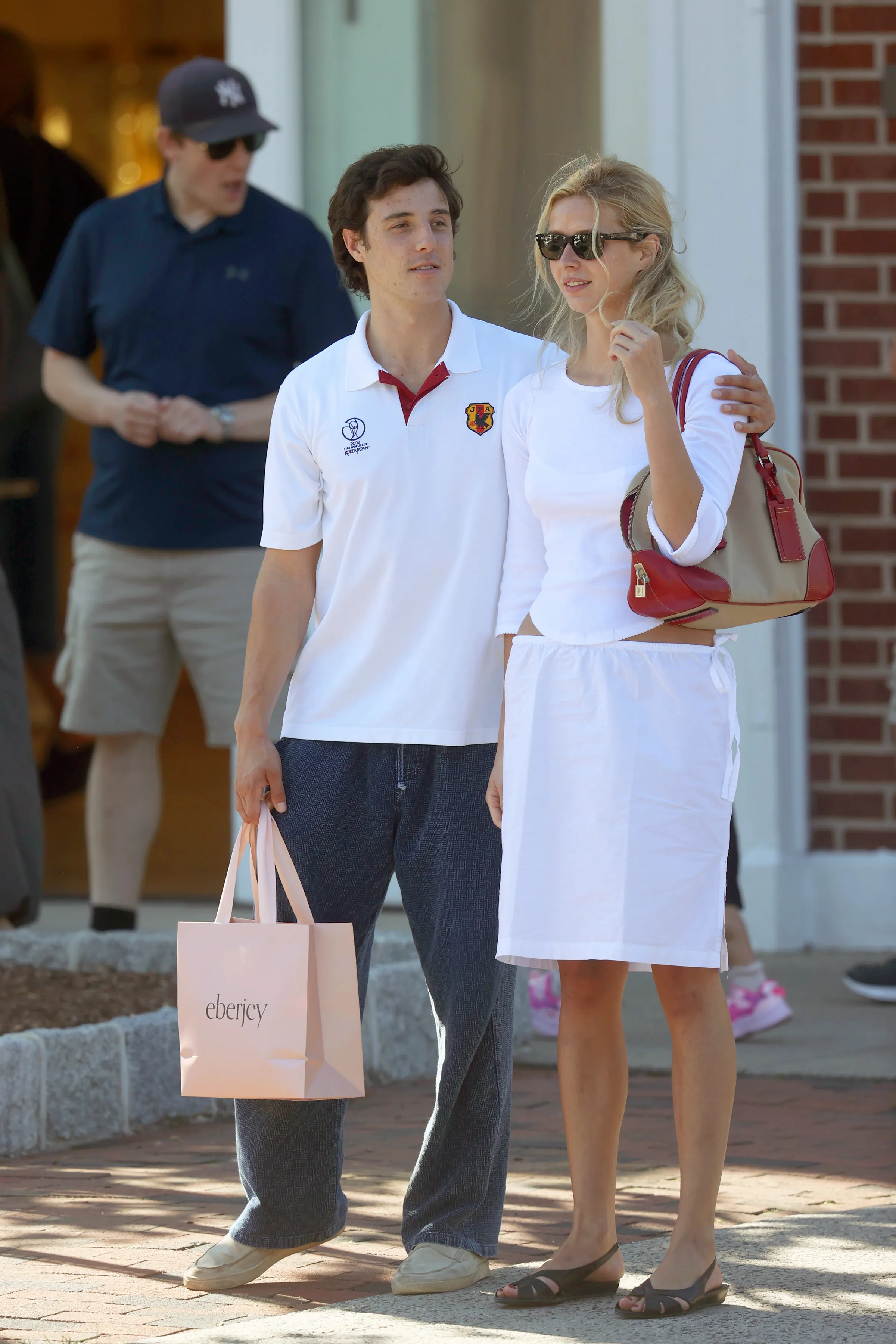 Apple Martin with her arm around a man while shopping in The Hamptons.