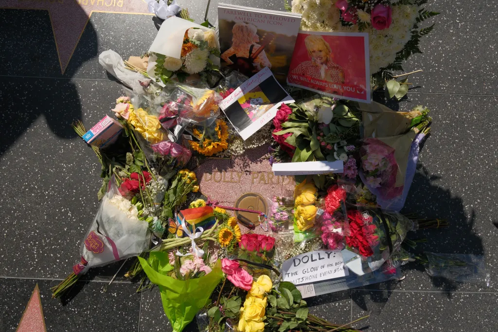 Flowers, cards, and memorials placed around Dolly Parton’s Hollywood Walk of Fame star.