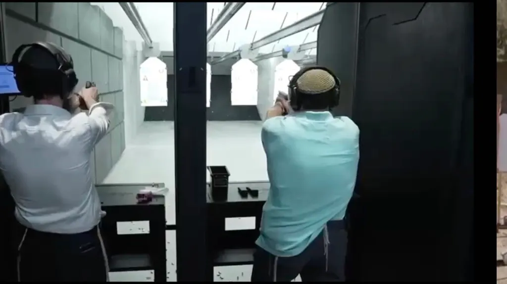 Two rabbis in a shooting range practicing firearm instruction.