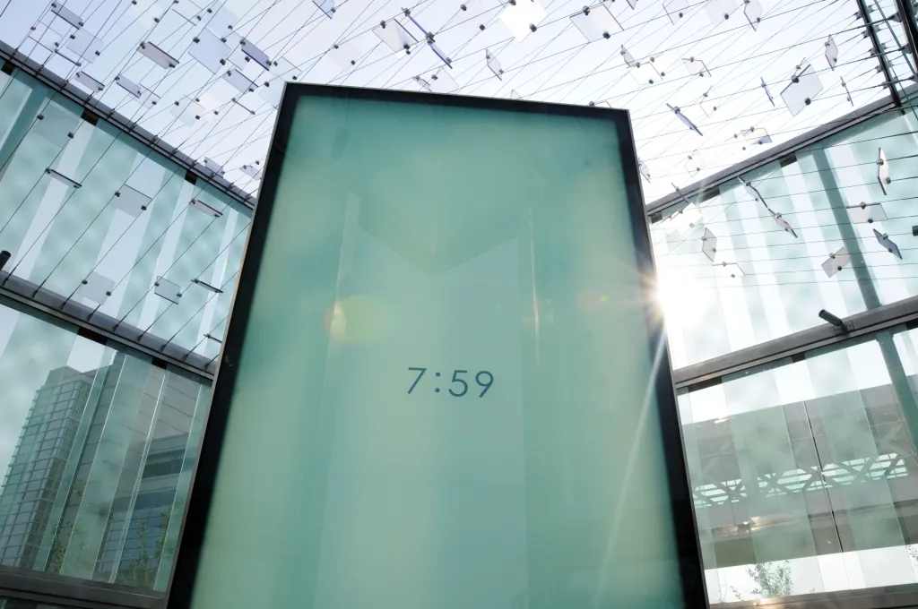 A digital clock on a dark display shows 