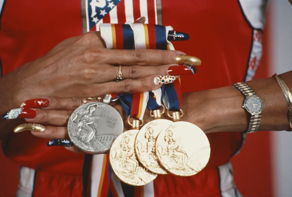 Florence Griffith-Joyner displays her three gold and one silver medal from the 1988 Summer Olympics.