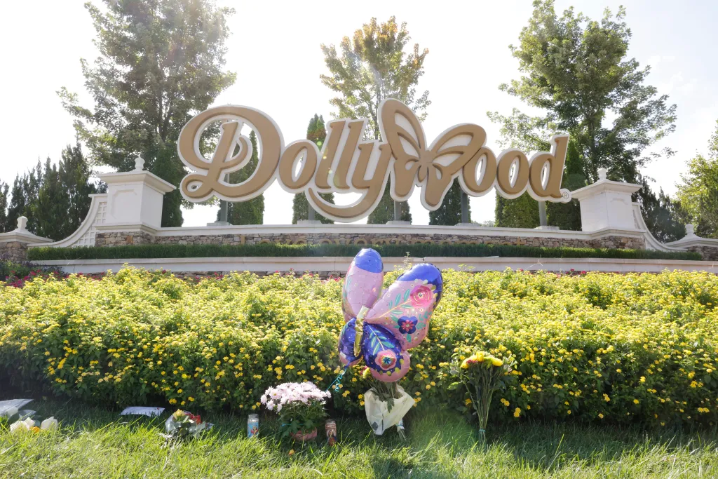 Flowers, balloons, and candles left at the entrance to Dollywood.