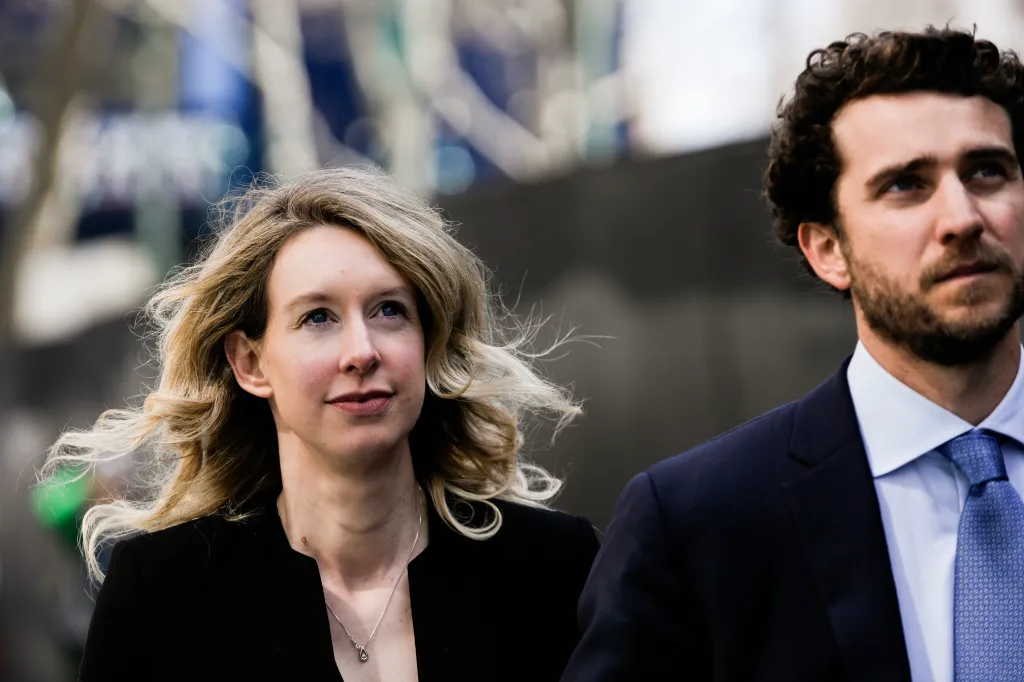 Elizabeth Holmes walks with Billy Evans after a court hearing.