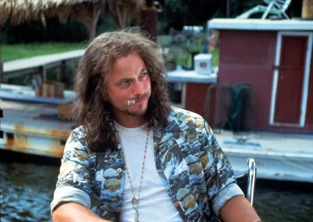 Gary Sinise as Lieutenant Dan in Forrest Gump with long hair and a white t-shirt